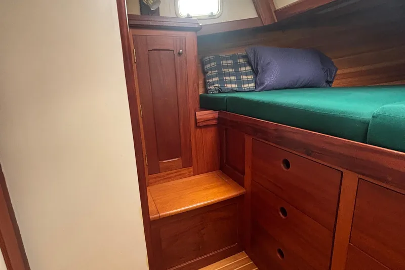 Carroll L Yacht Photos Pics Cozy wooden cabin interior with green bedding, Lowell 40 model, 2001.