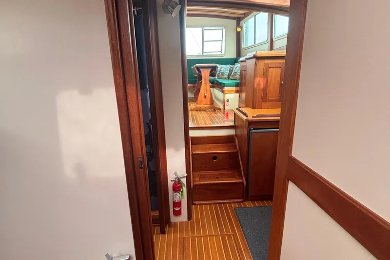 Carroll L Yacht Photos Pics Interior of 2001 Lowell 40 boat with wooden flooring and seating area.