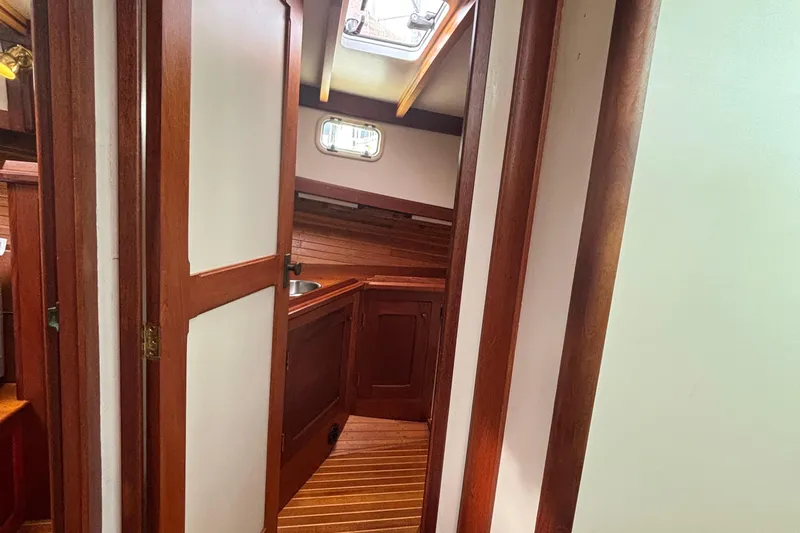Carroll L Yacht Photos Pics Interior of 2001 Lowell 40 boat with wooden cabinetry and flooring.