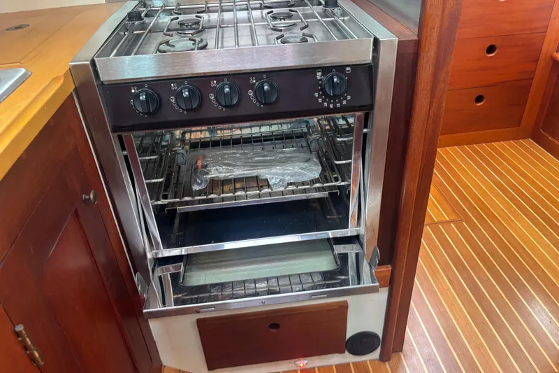 Carroll L Yacht Photos Pics Stainless steel stove and oven in wooden boat kitchen, Lowell 40, 2001 model.