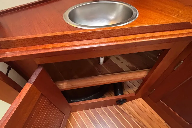 Carroll L Yacht Photos Pics Wooden cabinet with open doors, stainless steel sink, Lowell 40 model, 2001.