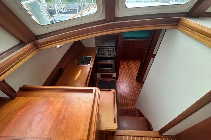 Carroll L Yacht Photos Pics Interior of a 2001 Lowell 40 boat featuring a compact kitchen area.