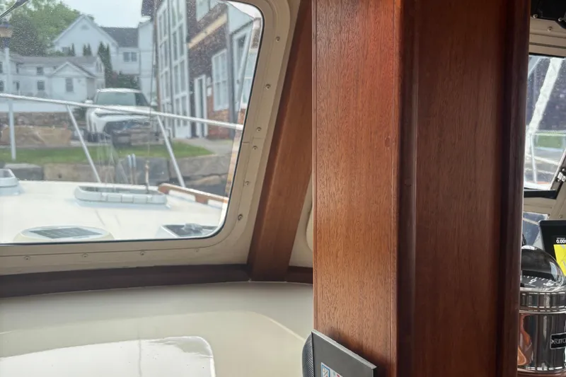 Carroll L Yacht Photos Pics Interior view of a 2001 Lowell 40 boat, showcasing wooden paneling and dockside scenery.