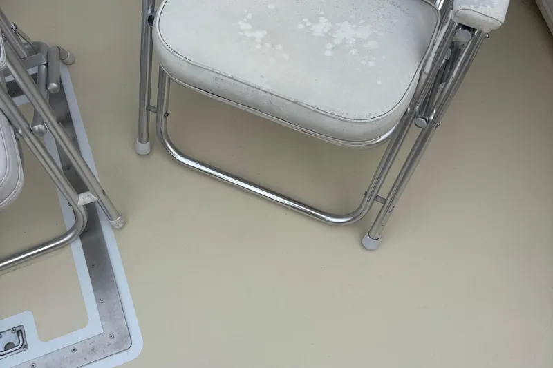 Carroll L Yacht Photos Pics White folding chairs on a beige boat deck, Lowell 40 model, 2001.