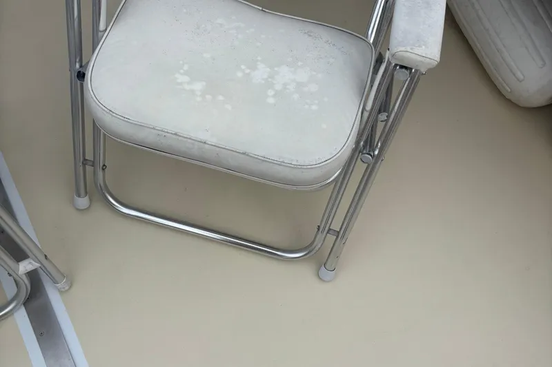 Carroll L Yacht Photos Pics White cushioned chair with metal frame on a Lowell 40 boat, 2001 model.