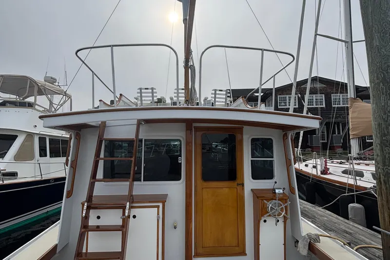 Carroll L Yacht Photos Pics 2001 Lowell 40 boat docked at marina, featuring wooden accents and ladder.
