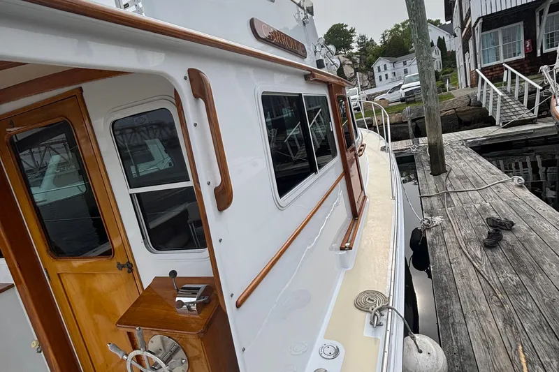 Carroll L Yacht Photos Pics Side view of a 2001 Lowell 40 boat docked at a wooden pier.