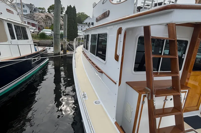 Carroll L Yacht Photos Pics 2001 Lowell 40 boat docked, featuring wooden ladder and white exterior.