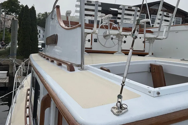 Carroll L Yacht Photos Pics Lowell 40 yacht deck, 2001 model, featuring steering wheel and seating, docked at marina.