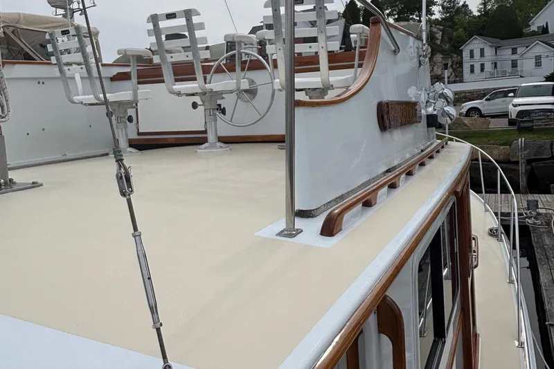 Carroll L Yacht Photos Pics 2001 Lowell 40 boat deck with chairs and steering wheel at dock.