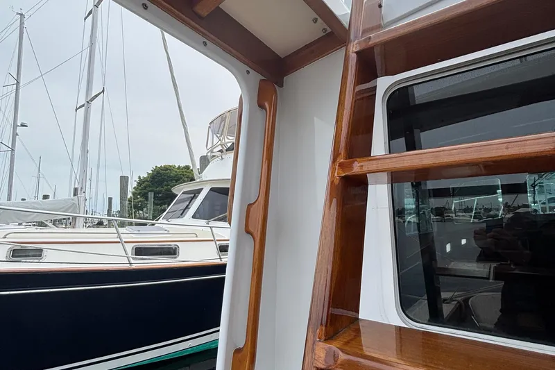 Carroll L Yacht Photos Pics Wooden ladder on a Lowell 40 boat, docked near other sailboats, 2001 model.
