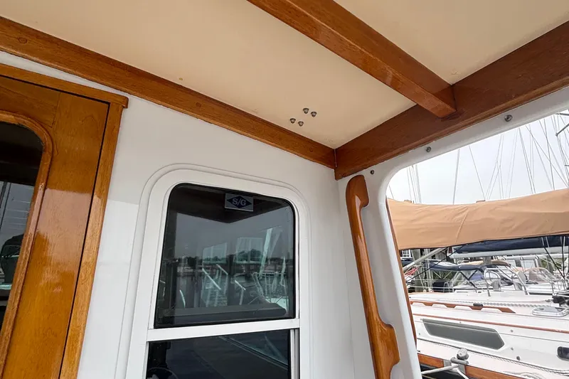 Carroll L Yacht Photos Pics Interior view of a 2001 Lowell 40 boat with wooden trim and window.