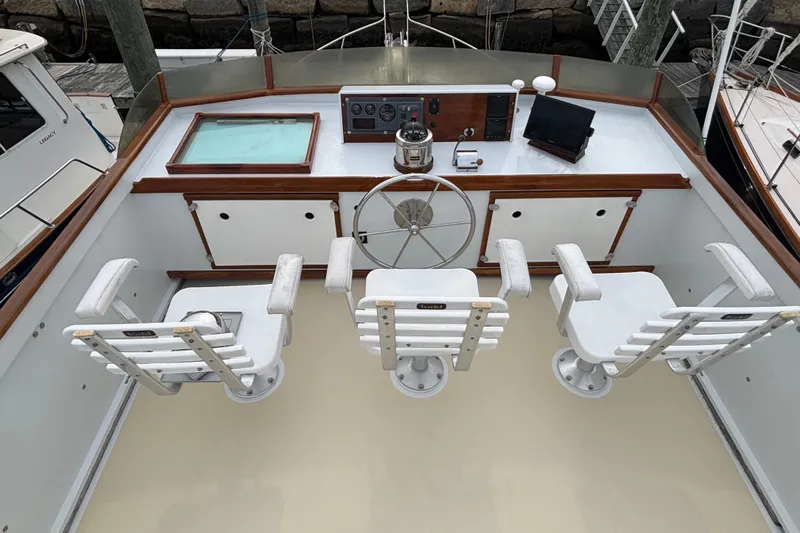 Carroll L Yacht Photos Pics Cockpit of 2001 Lowell 40 boat with helm, three chairs, and navigation equipment.