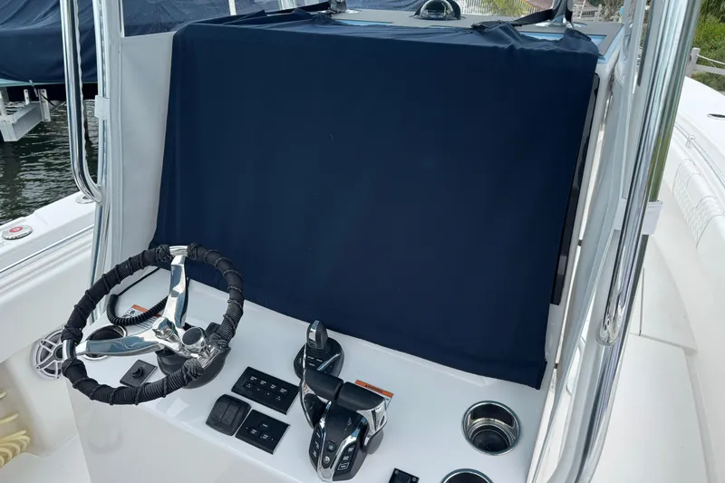  Yacht Photos Pics 2024 Contender 30 Tournament boat helm with covered console and steering wheel.