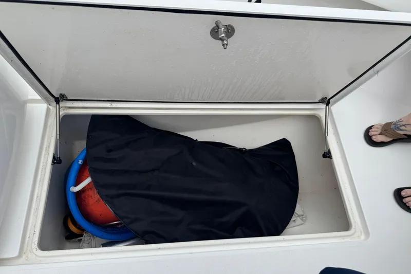  Yacht Photos Pics Open storage compartment on 2024 Contender 30 Tournament boat with various items inside.