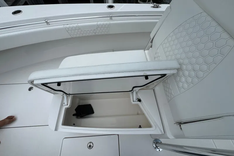  Yacht Photos Pics 2024 Contender 30 Tournament boat with open storage compartment and hexagonal seat pattern.