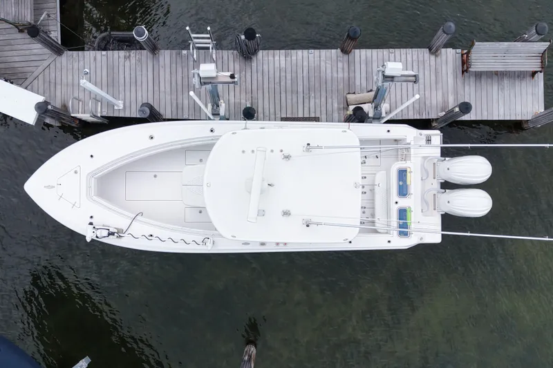  Yacht Photos Pics Aerial view of 2024 Contender 30 Tournament boat docked at a wooden pier.