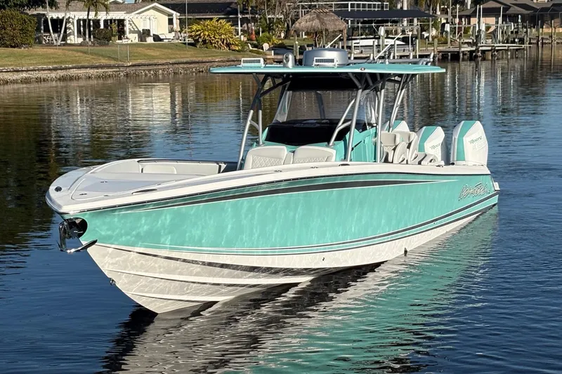  Yacht Photos Pics 2024 Nor-Tech 390 Sport Center Console boat on calm water, featuring a sleek turquoise design.