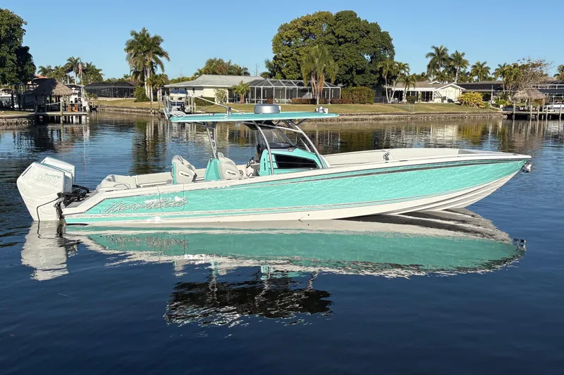  Yacht Photos Pics 2024 Nor-Tech 390 Sport Center Console boat on calm water, surrounded by palm trees.