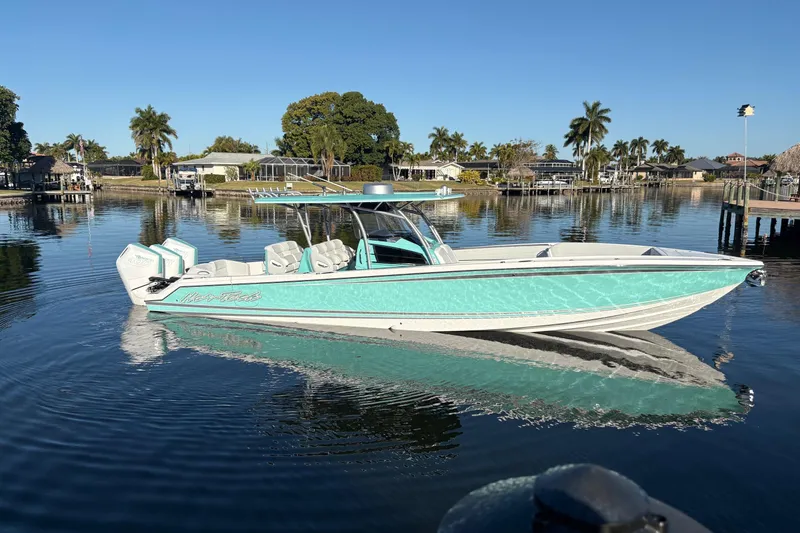  Yacht Photos Pics 2024 Nor-Tech 390 Sport Center Console boat on calm water, surrounded by palm trees.