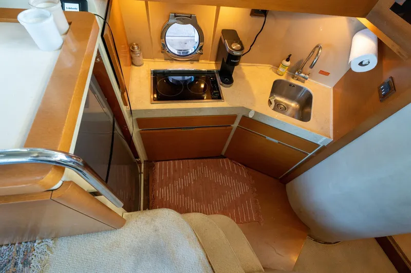  Yacht Photos Pics Compact kitchen in 2013 Azimut 40 Flybridge yacht with sink, stove, and porthole.