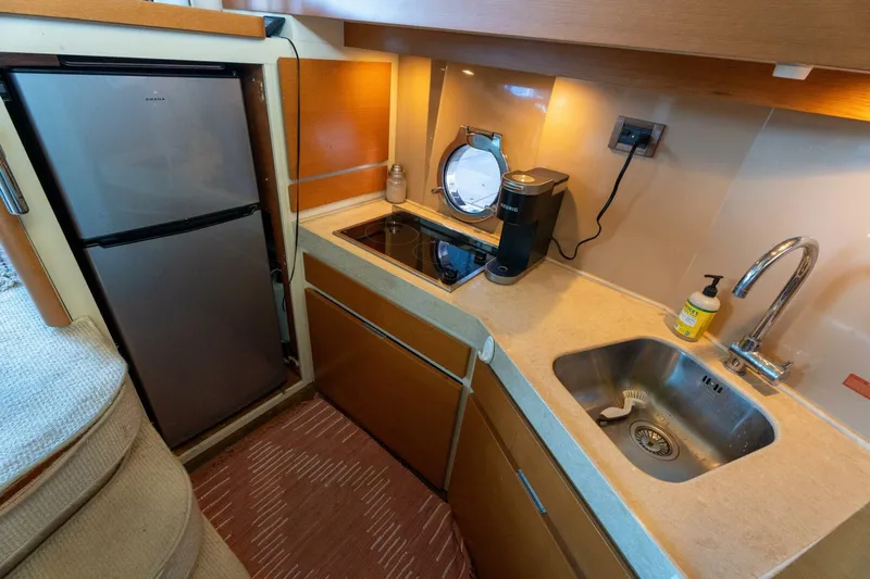  Yacht Photos Pics Compact kitchen in 2013 Azimut 40 Flybridge yacht with sink, stove, and fridge.