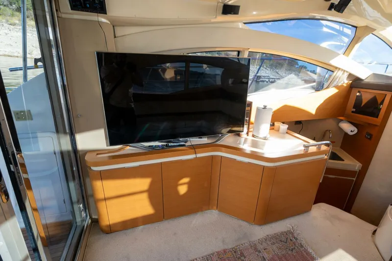  Yacht Photos Pics Interior of 2013 Azimut 40 Flybridge yacht with TV and wooden cabinetry.