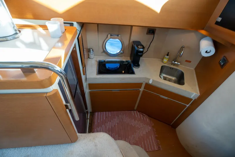  Yacht Photos Pics Compact kitchen area in 2013 Azimut 40 Flybridge yacht with sink and stove.