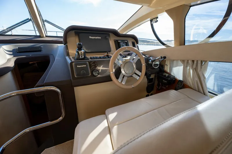  Yacht Photos Pics Luxurious helm of 2013 Azimut 40 Flybridge yacht with modern navigation equipment.