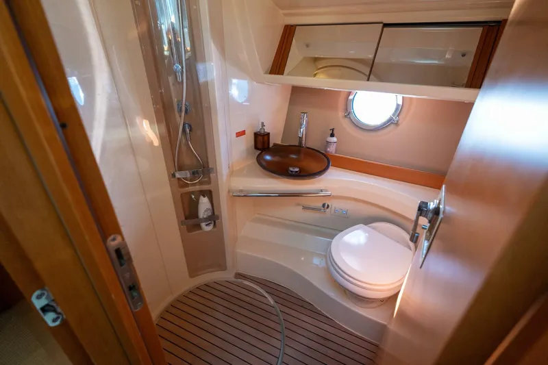  Yacht Photos Pics Luxurious bathroom in 2013 Azimut 40 Flybridge yacht with modern fixtures and wooden accents.