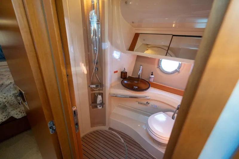  Yacht Photos Pics Luxurious bathroom in 2013 Azimut 40 Flybridge yacht with modern fixtures and porthole window.