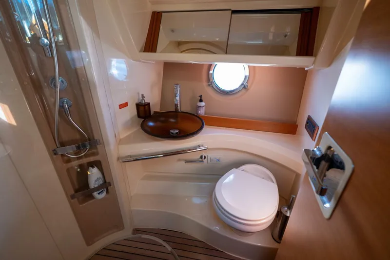 Yacht Photos Pics Luxurious bathroom in 2013 Azimut 40 Flybridge yacht with modern fixtures and porthole window.