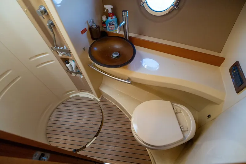  Yacht Photos Pics Luxurious bathroom in 2013 Azimut 40 Flybridge yacht with modern fixtures and wooden flooring.