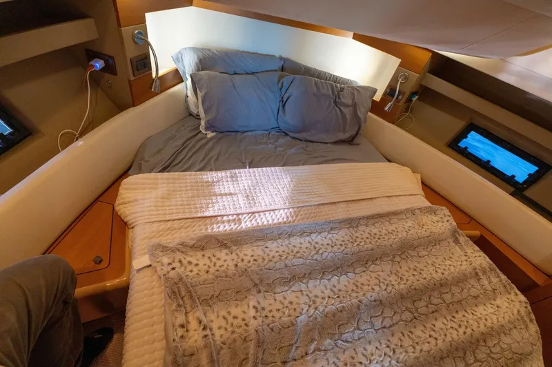  Yacht Photos Pics Cozy bedroom in 2013 Azimut 40 Flybridge yacht with plush bedding and modern amenities.