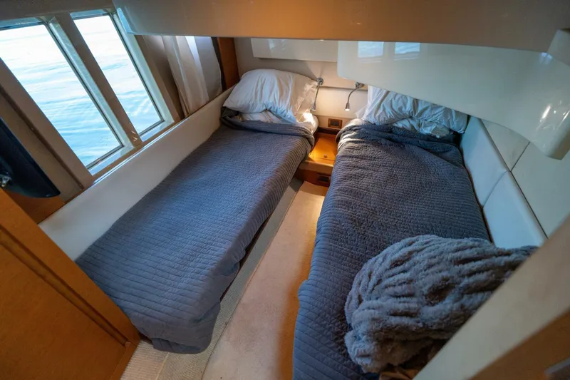  Yacht Photos Pics Twin beds in 2013 Azimut 40 Flybridge cabin with cozy bedding and window view.