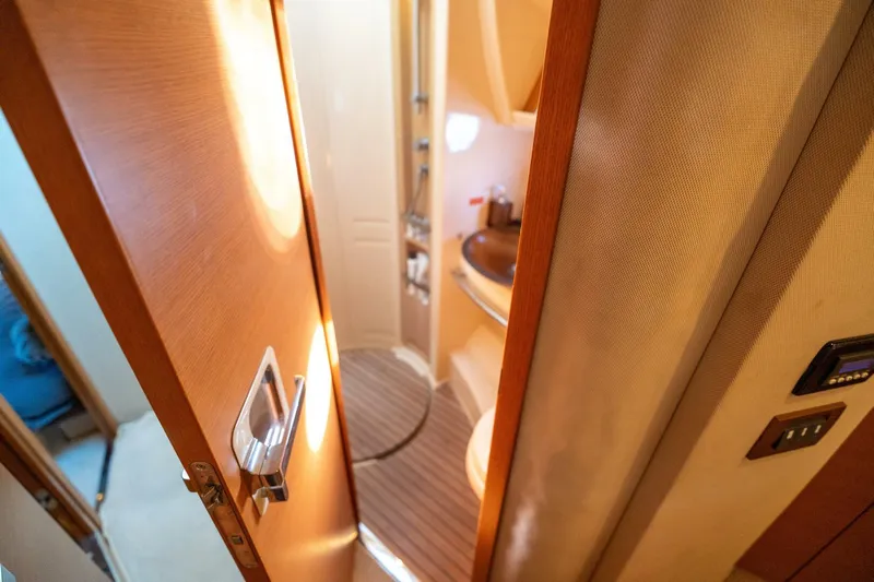  Yacht Photos Pics Interior view of 2013 Azimut 40 Flybridge yacht bathroom with wooden door.
