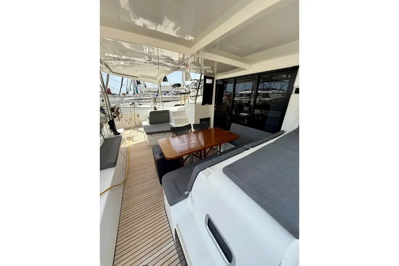 Keyma Yacht Photos Pics Spacious deck of 2020 Lagoon 42 catamaran with seating and wooden table.