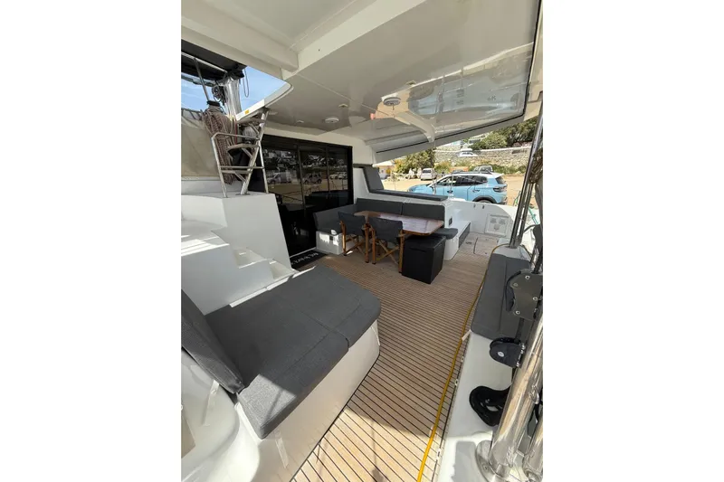 Keyma Yacht Photos Pics 2020 Lagoon 42 yacht interior with seating area and wooden flooring.