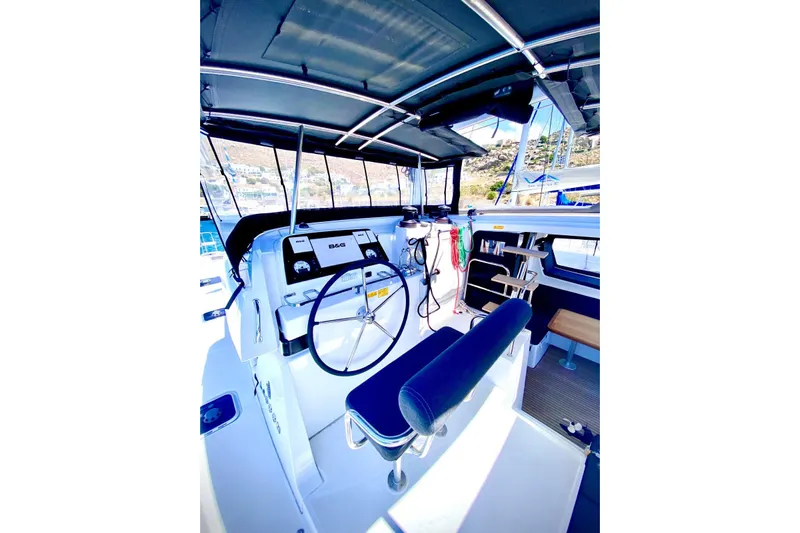 Keyma Yacht Photos Pics Helm station of 2020 Lagoon 42 catamaran with modern navigation equipment and seating.