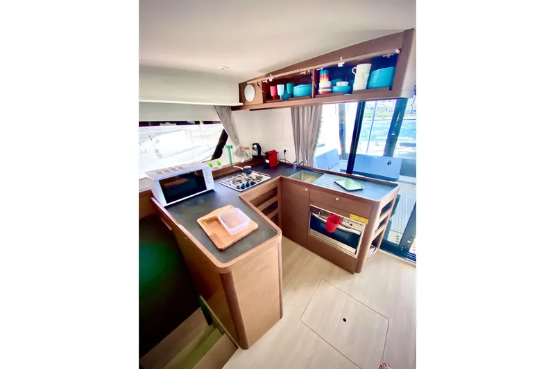 Keyma Yacht Photos Pics Modern kitchen interior of 2020 Lagoon 42 catamaran with appliances and storage.