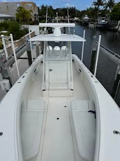 Reel Craft Yacht Photos Pics 2024 SeaVee 340Z boat docked in a marina, showcasing sleek design and spacious deck.