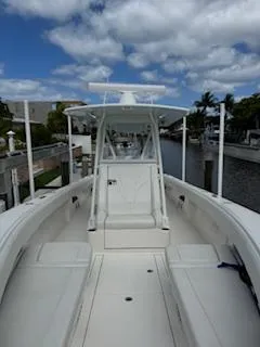 Reel Craft Yacht Photos Pics 2024 SeaVee 340Z boat docked, showcasing sleek design and spacious deck under a partly cloudy sky.