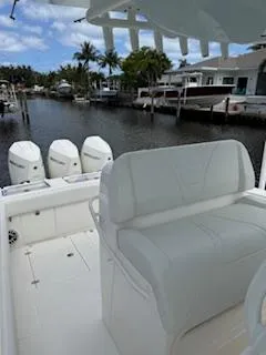 Reel Craft Yacht Photos Pics 2024 SeaVee 340Z boat with triple engines docked in a scenic canal setting.