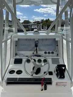 Reel Craft Yacht Photos Pics 2024 SeaVee 340Z boat dashboard with Garmin navigation system and steering wheel.