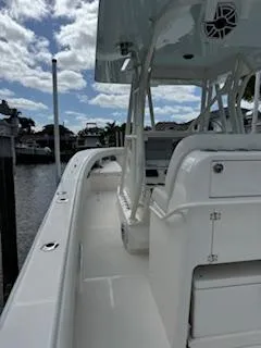 Reel Craft Yacht Photos Pics 2024 SeaVee 340Z boat docked, showcasing sleek design and spacious deck under a partly cloudy sky.