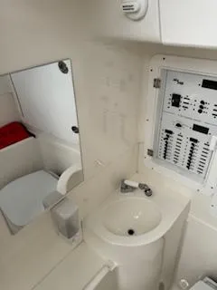 Reel Craft Yacht Photos Pics 2024 SeaVee 340Z boat interior with sink, mirror, and control panel.