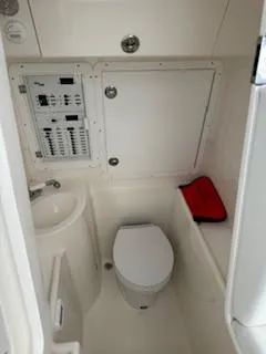 Reel Craft Yacht Photos Pics 2024 SeaVee 340Z boat interior with toilet, sink, and control panel.