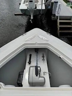 Reel Craft Yacht Photos Pics 2024 SeaVee 340Z boat bow with anchor storage, docked near wooden pier.