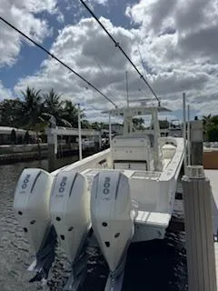 Reel Craft Yacht Photos Pics 2024 SeaVee 340Z boat docked, featuring triple outboard engines under a partly cloudy sky.