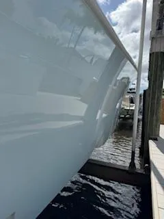 Reel Craft Yacht Photos Pics 2024 SeaVee 340Z boat docked, showcasing sleek hull design and reflective surface.